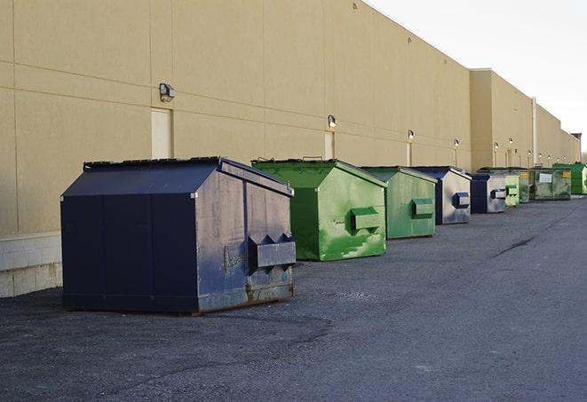 a pile of demolition waste sits beside a dumpster in a parking lot in Floral City